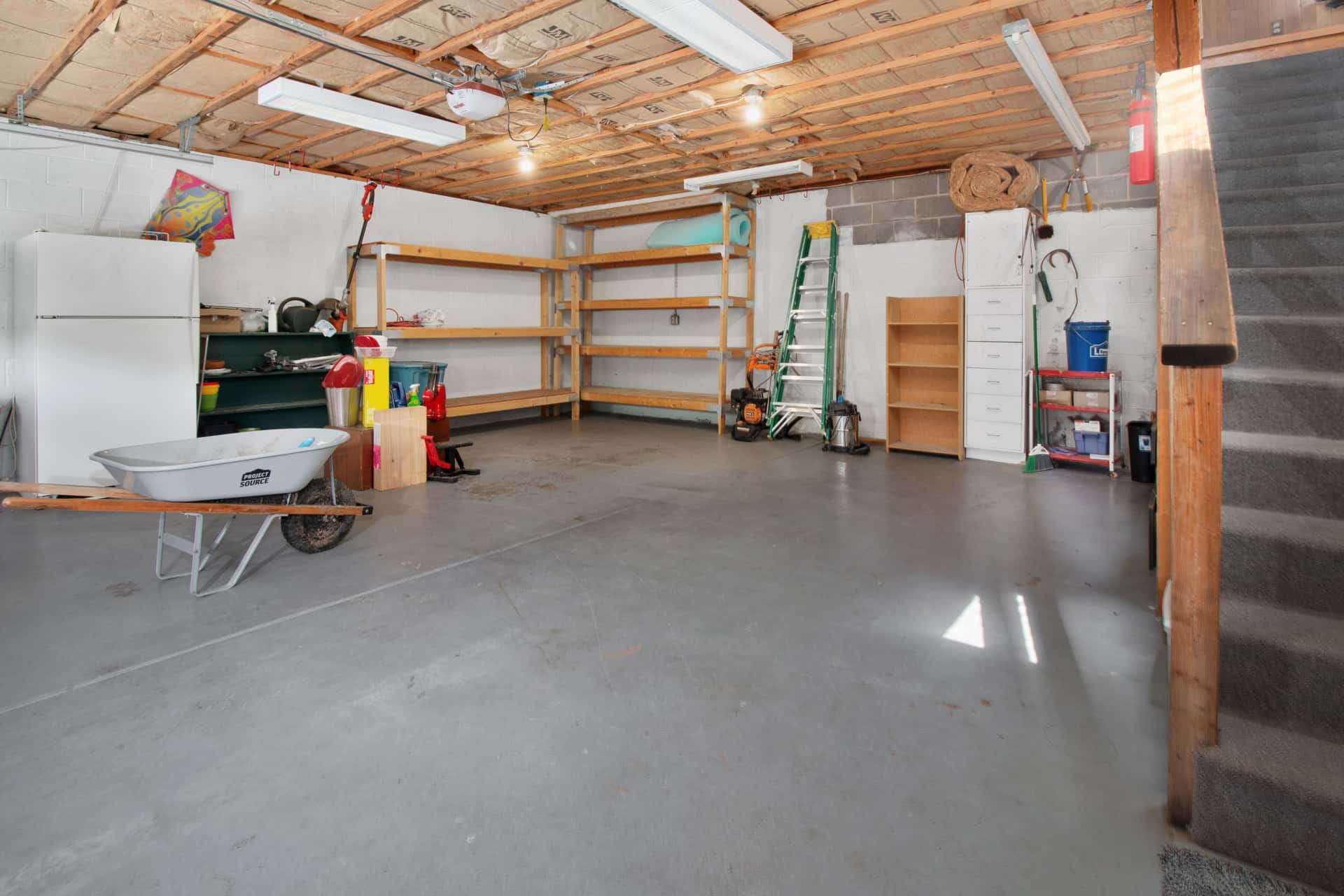 An empty garage bay in soft light, ready to become a first woodworking shop