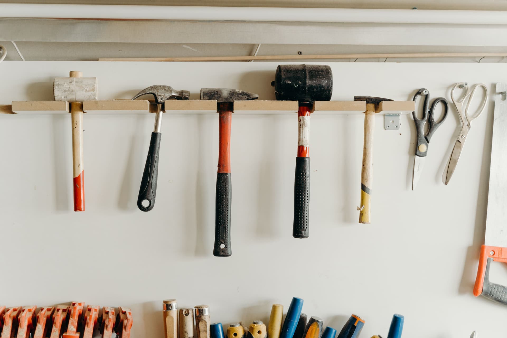 An organized garage woodworking workshop with tools on the wall