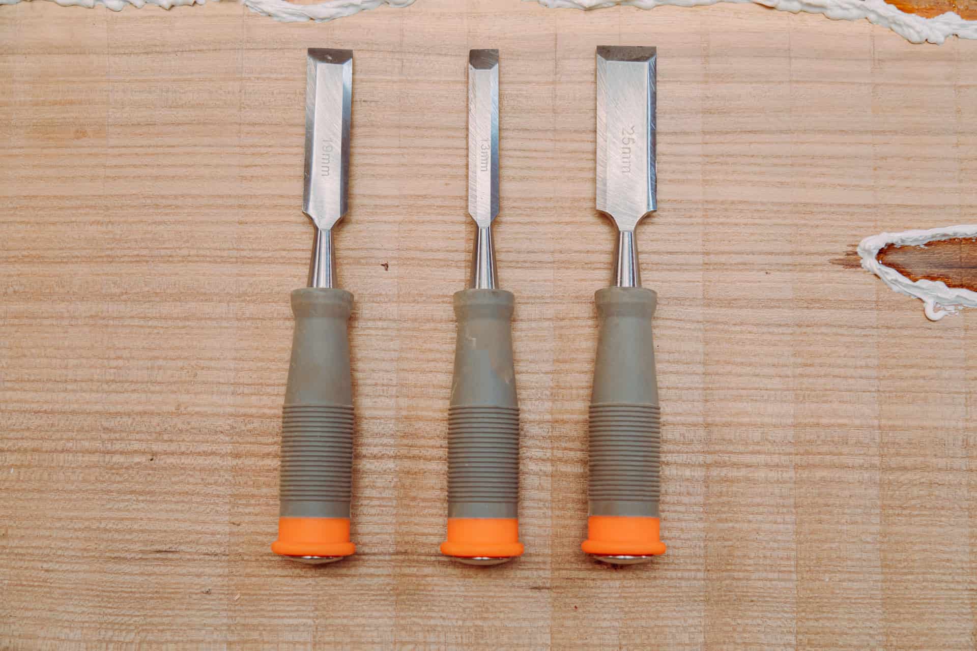 Wood chisels and hand tools laid out on a workbench